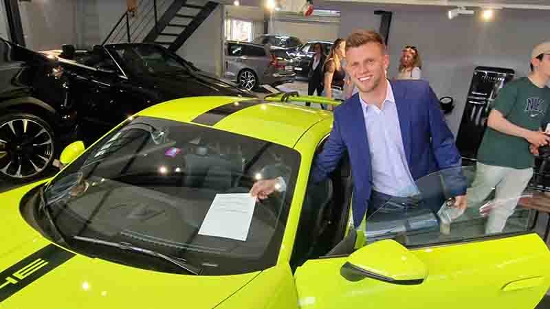 Sammy, a student from Weinberg United Business Schools, selling his first luxury car at Vibes, a high-end auto dealership.